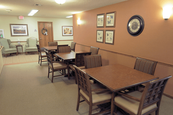 Common area with seating and decor in a senior living facility