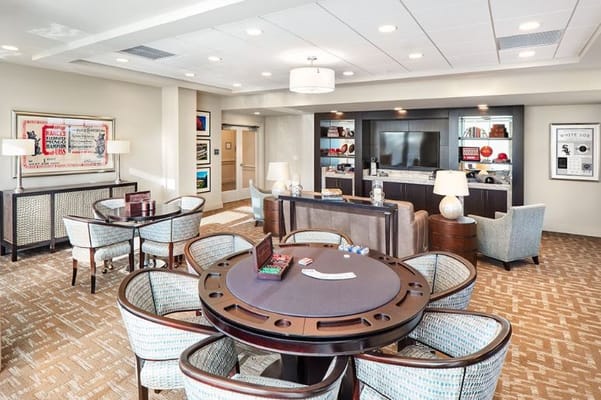 Cozy community lounge with gaming table and seating area