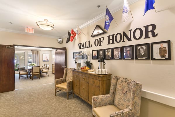 Interior view of the Wall of Honor with flags and photographs in Silverado Escondido.