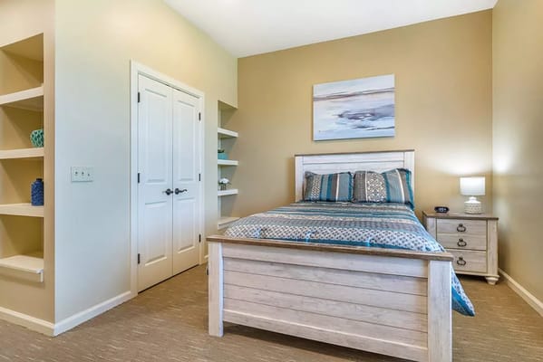 Comfortable bedroom with a bed and decorative shelves