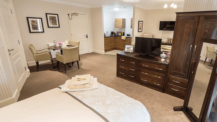 A well-furnished private room in a care facility