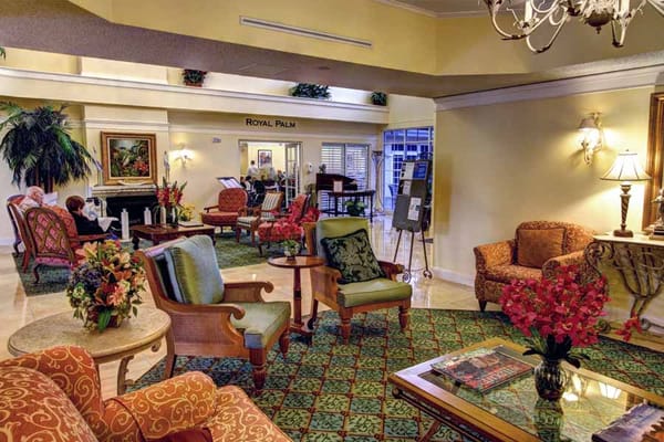 Cozy lobby with seating and floral decorations at Five Star Premier Residences of Plantation.