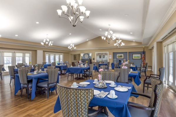 Bright dining room with tables set for a meal