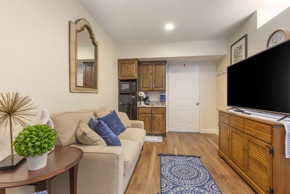 Cozy living area with kitchen in a resident room