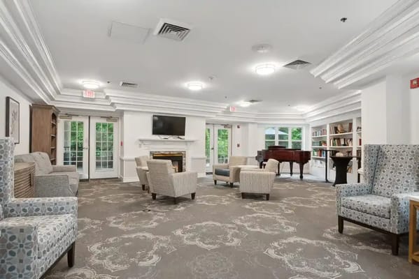 Cozy common area with chairs and a piano