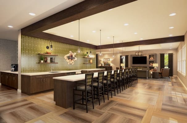 Modern kitchen area with a long counter and seating at The Summit Senior Living