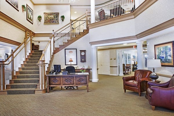 Welcoming lobby with staircase and reception desk