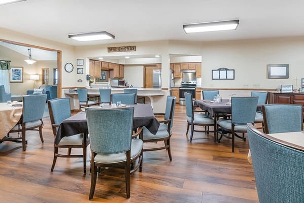 Dining area with tables and chairs set for meal service