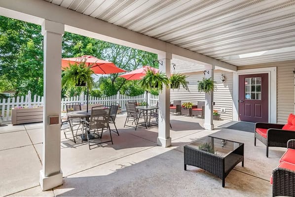 Covered patio with seating and umbrellas