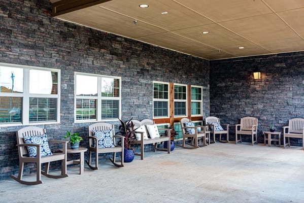 Outdoor seating area with rocking chairs and plants