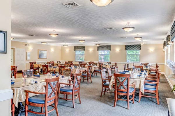 Spacious dining room with tables set for meals