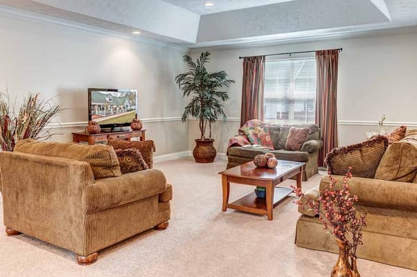 A cozy living room featuring comfortable sofas and a television.