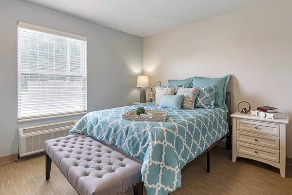 Cozy bedroom with blue decor and natural light