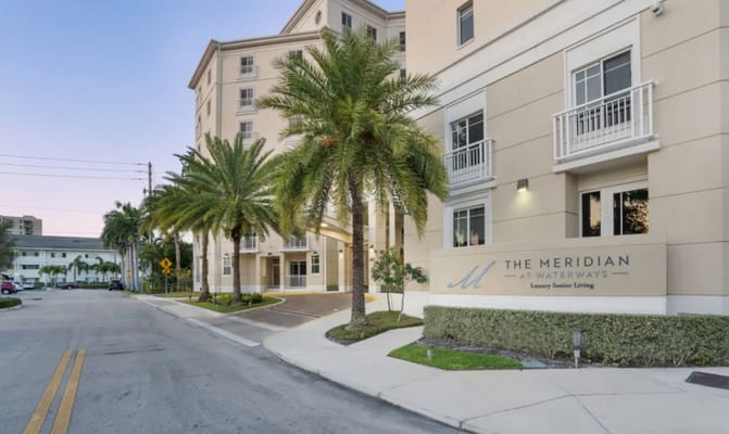 Entrance of The Meridian at Waterways with palm trees