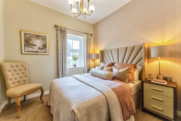 Well-appointed bedroom with soft bedding and decorative chair