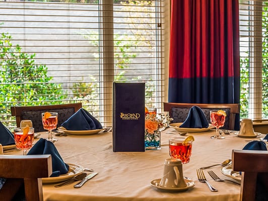 Elegantly set dining table with drinks and menu at The Windsor of Gainesville.