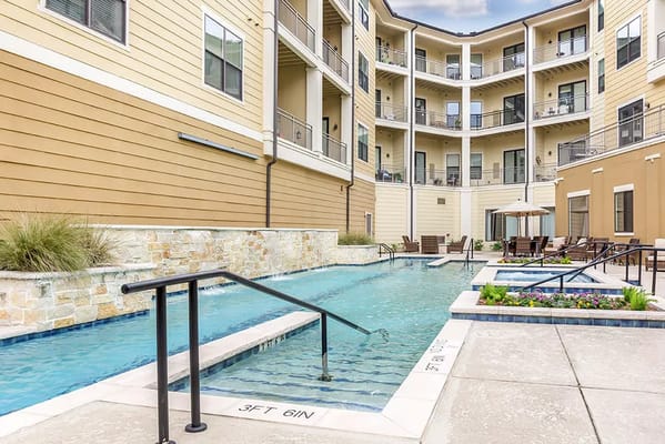 View of the outdoor pool surrounded by the building at The Solana Preserve Vintage Park