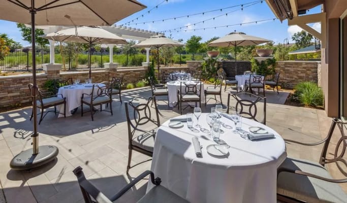 Outdoor dining area with tables and umbrellas