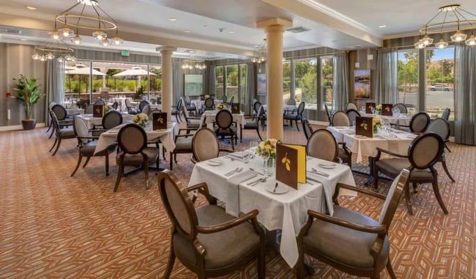 Elegant dining room with tables set for residents