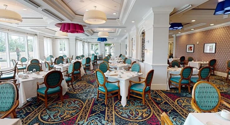 Elegant dining room with tables set for meals