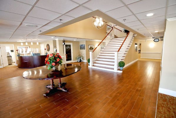 View of the lobby with a round table and staircase
