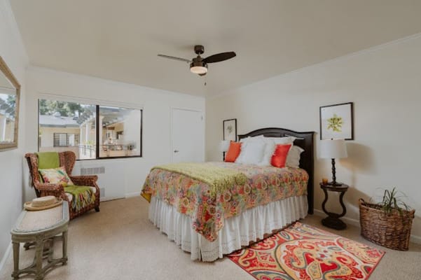 Cozy bedroom with a colorful quilt and natural light