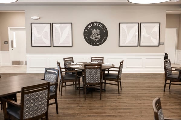 Dining area with tables and framed art on the wall