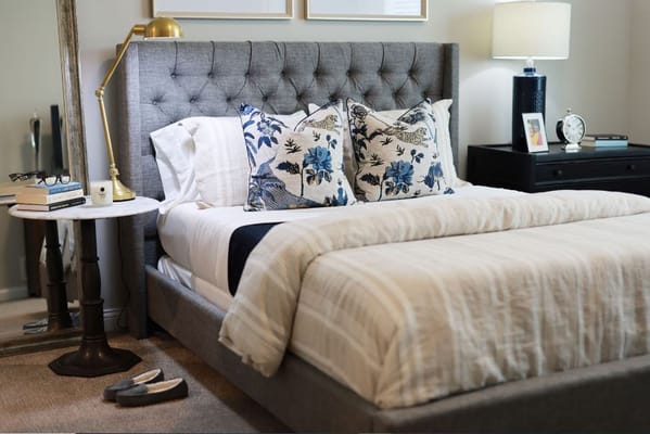Cozy bedroom with decorative pillows and lamp