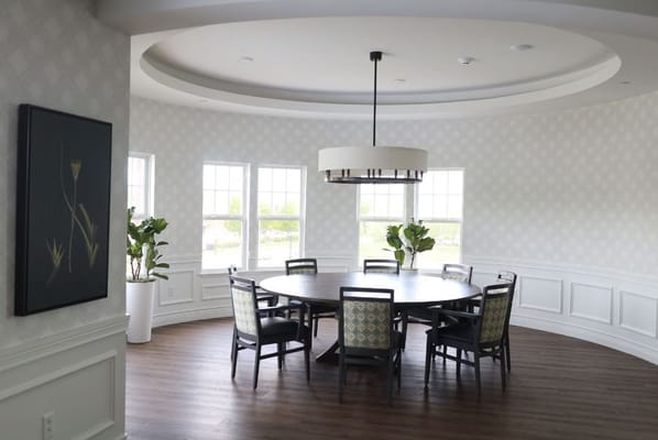 Bright interior common area with a large round table