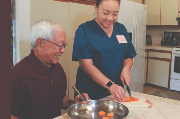 Staff assisting a resident with food preparation