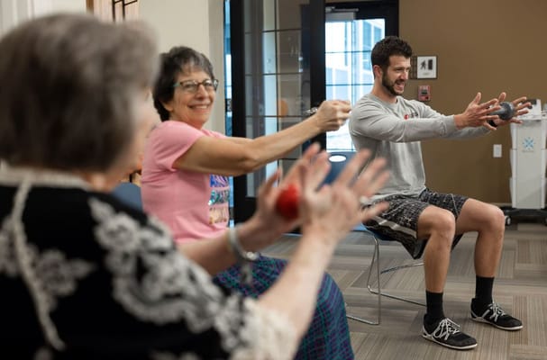 Residents participating in a group exercise session indoors