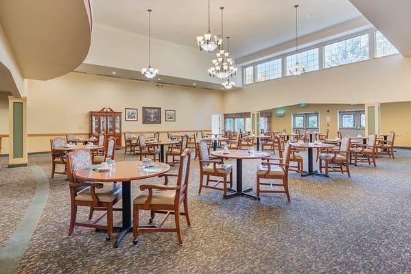 Bright dining room with multiple tables and chairs