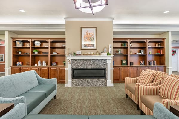 Common area with comfortable seating and bookshelf