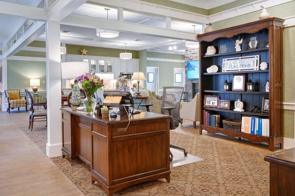 A warm and inviting lobby with a reception desk, floral arrangements, and cozy seating areas.