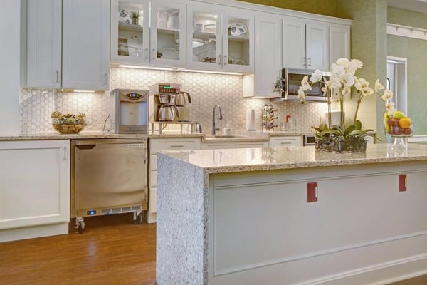 Stylish kitchen with granite counter and cabinetry at Sunrise of Westminster