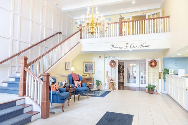 Spacious and inviting lobby with staircase and seating area