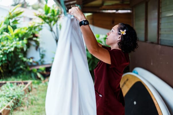 Staff member hanging laundry in the garden area