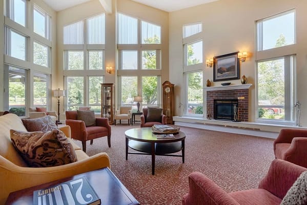 Bright common area with large windows and comfortable seating