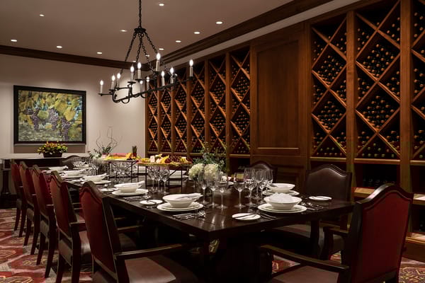 Elegant dining room with a large table and wine display