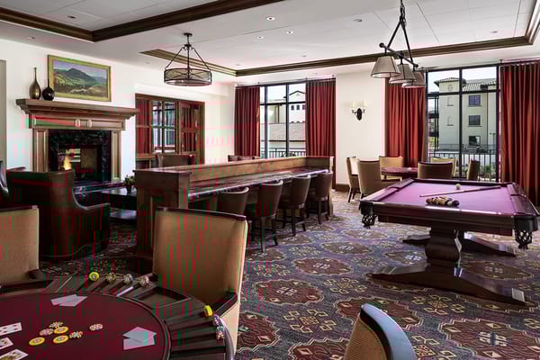 Interior of a common area with poker tables and a bar