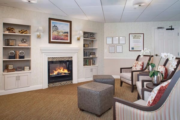 Cozy living room with fireplace and comfortable seating at Sunrise of Yorba Linda