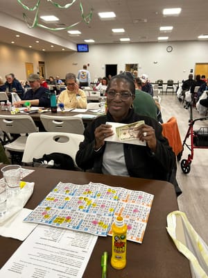 Resident enjoying bingo with a winning card