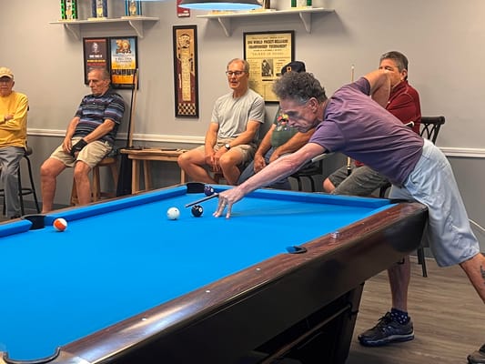 Residents playing billiards in a common area