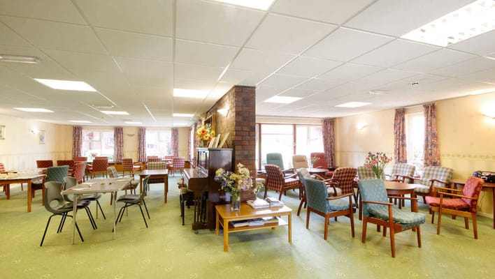 Common area with seating and tables for residents