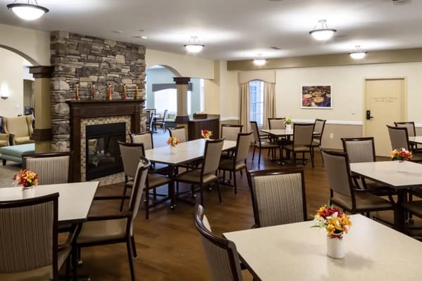 Dining area with tables and flowers in a bright room
