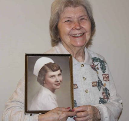 Resident holding a framed photo of their younger self