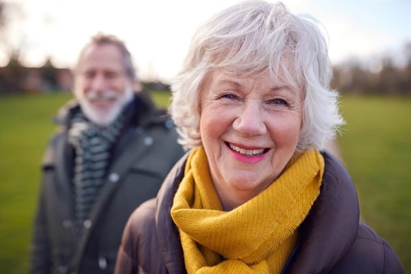 Happy senior couple smiling in a park