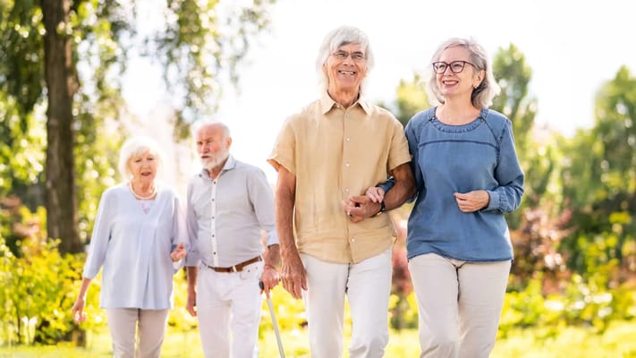 Seniors walking together in a garden