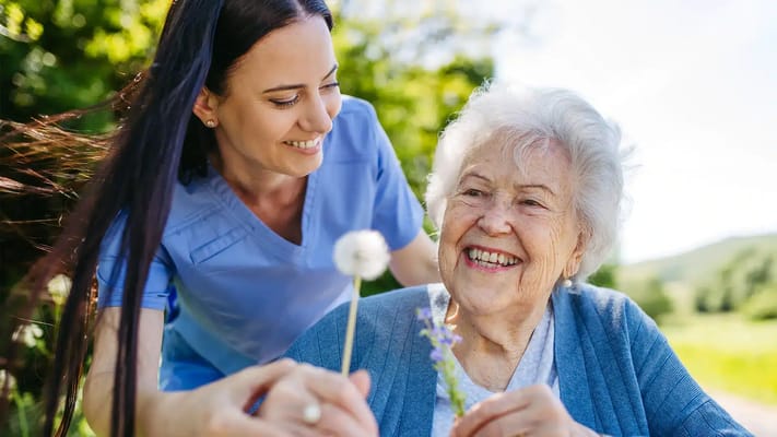 Caregiver and senior resident enjoying time outdoors