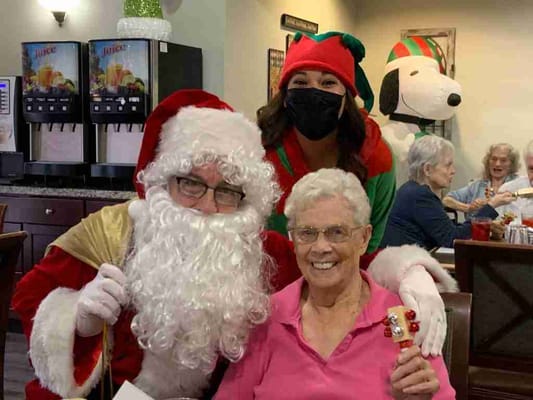 Residents celebrating Christmas with Santa and an elf